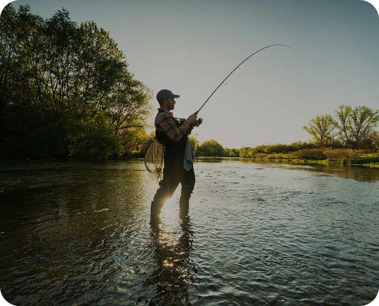 Person fly fishing in a calm river.